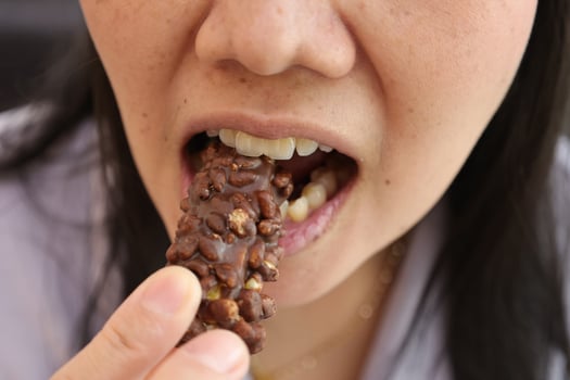 Close-up view of mouth eating food photo