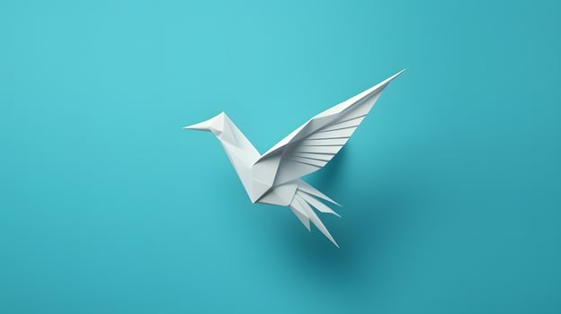 Paper origami bird isolated on blue background photo
