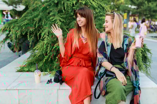Friendship and communication concept. Two smiling woman talking and spending time  together. photo