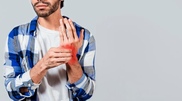 People with arthritis and hand pain, Man with pain in hands with copy space, Young suffering person with pain in hand joints. Man with arthritis rubbing his hands photo