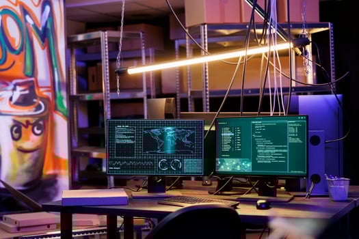 Computer screens displaying data and ransomware code at hackers workspace. Malicious software cracking password on monitors in abandoned warehouse with graffiti and neon light photo