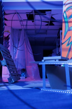 Neglected building filled with fluorescent bright lights, urban space displaying graffiti spray paint and purple neon light. Empty deserted warehouse being illuminated and grungy. photo