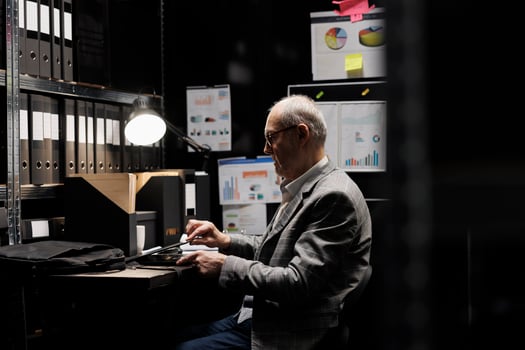 Management executive businessman starting job shift, opening work laptop. Accounting employee surrounded by financial repository cabinet office statistics data bureaucratic paperwork photo