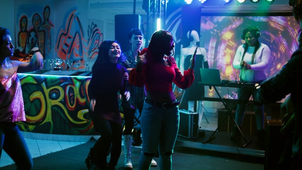 Diverse people starting dance battle to show off funky music at nightclub, enjoying modern disco party with group of friends. Adults doing breakdance battle at fun event. Handheld shot. photo