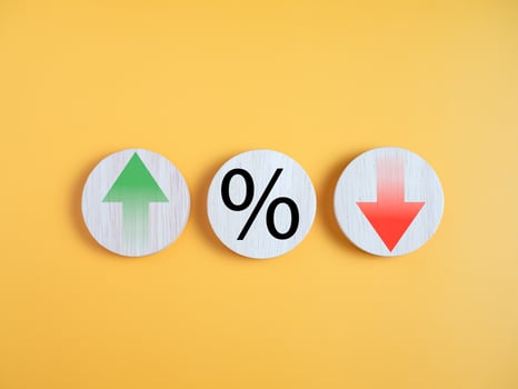 Interest rate financial and mortgage rates concept. Circle wood with icon percentage symbol and arrow up and down direction on yellow background. photo