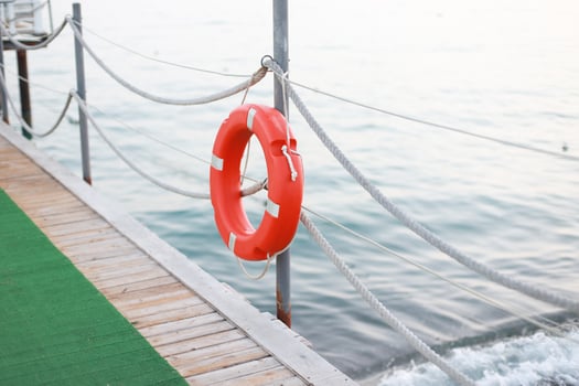 Life jacket hanging on a pantone on the beach photo