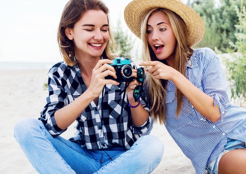 Two happy female friends, Enthusiastic model with her personal photographer . photo