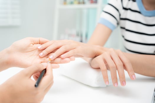 Woman receive care service by professional Beautician Manicure at spa centre. Nail beauty salon use nail file for Glazing treatment. manicurist make nail customer to beautiful. body care spa treatment photo