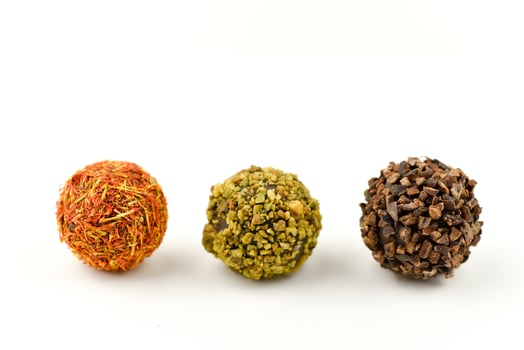 Handmade chocolate candies on white background photo