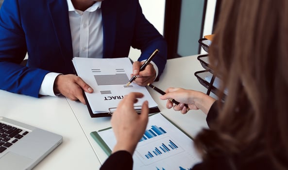 Entrepreneur Asian businessman and businesswoman discussing new business project in tablet in modern Meeting In Modern Office, Asian business casual concept. photo