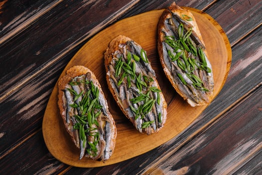 Top view pickled anchovies with spring onions photo