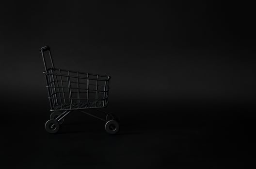 Black shoping cart on black background for Black Friday shopping sale concept. photo