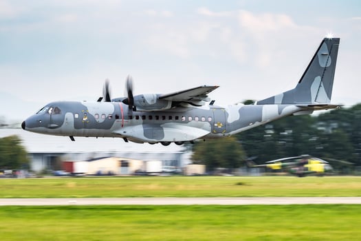 Untitled military transport plane at air base. Airport and airfield. Air force and army flight operation. Aviation and aircraft. Air lift. Military industry. Fly and flying. photo
