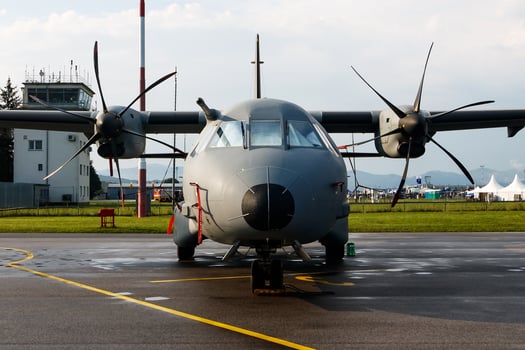 Untitled military transport plane at air base. Airport and airfield. Air force and army flight operation. Aviation and aircraft. Air lift. Military industry. Fly and flying. photo