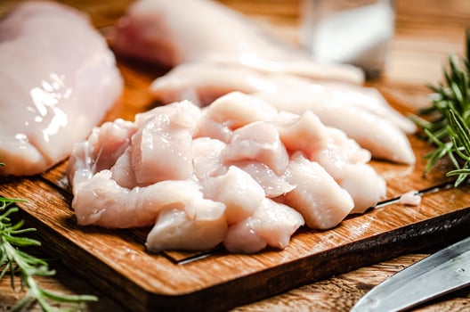 Sliced chicken fillet. On cutting board. photo
