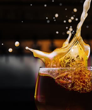 closeup splashes glass of dark Belgian beer photo