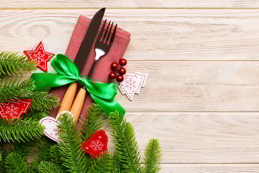 Top view of festive cutlery on new year wooden background. Christmas decorations with empty space for your design. Holiday dinner concept photo