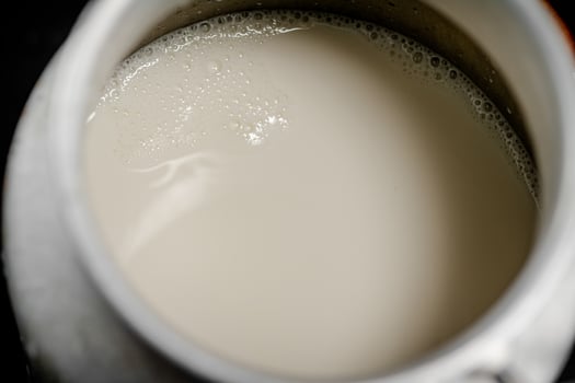 Village milk in a can. Macro background. photo