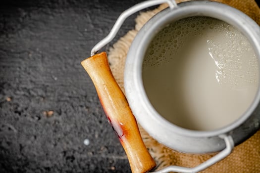 Fresh milk in a can on the table. photo