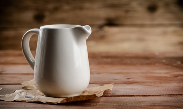 A jug of fresh milk on the table. photo