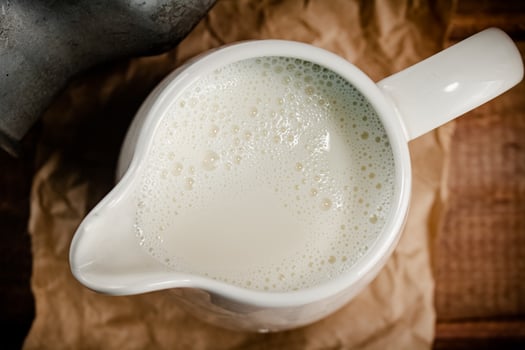 A jug of fresh milk on the table. photo