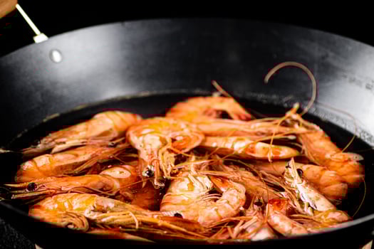 Saucepan with cooked boiled shrimp. photo