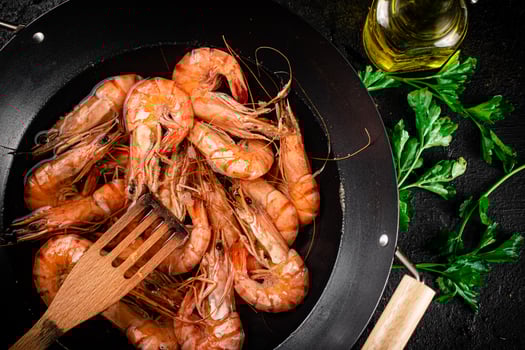 Pot of cooking shrimp with parsley. photo