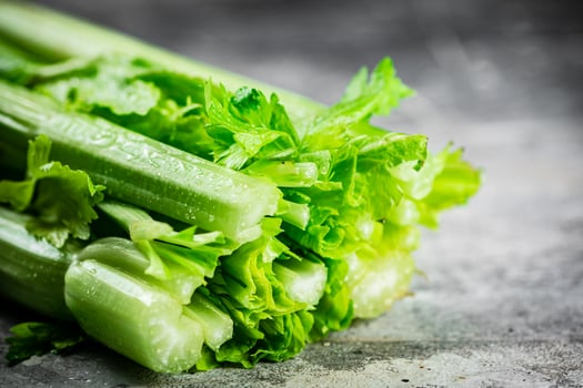 A stalk of fresh celery on the table. photo