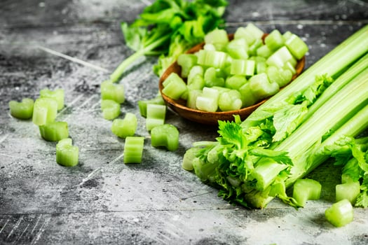 Cut into small pieces of celery in a plate. photo