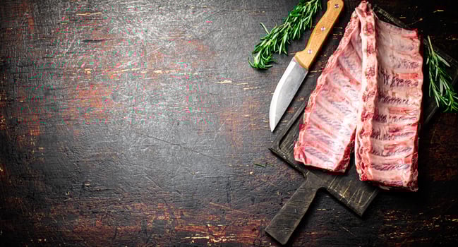Raw ribs on a cutting board. photo