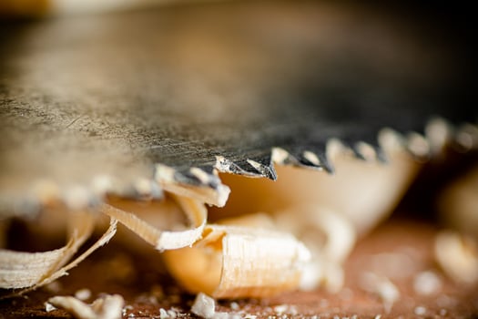 Hand saw blade on a wooden background. photo