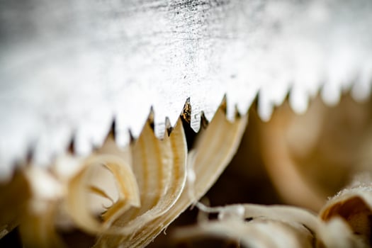 Hand saw blade on a wooden background. photo
