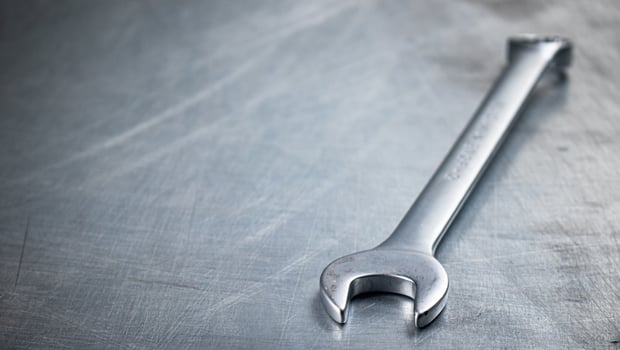 Metal wrench on the table. photo