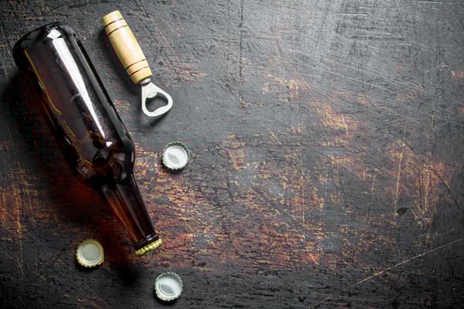 Glass beer bottle and opener. photo
