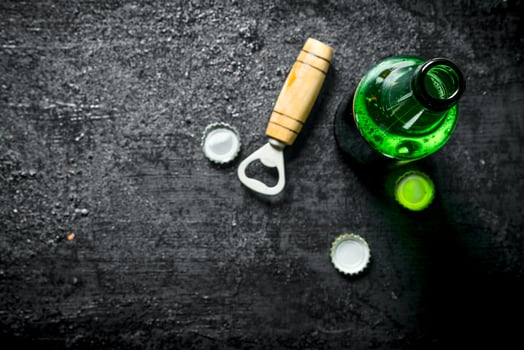 Bottle of beer and opener. photo