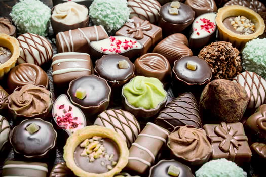 Chocolate candies with nuts and various fillings. photo