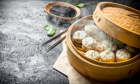 Hot dumplings manta in a bamboo steamer. photo