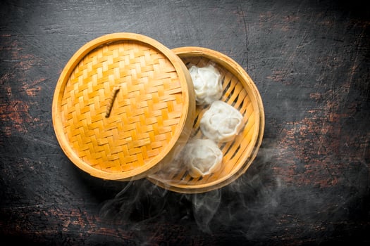 Hot dumplings manta in a bamboo steamer. photo