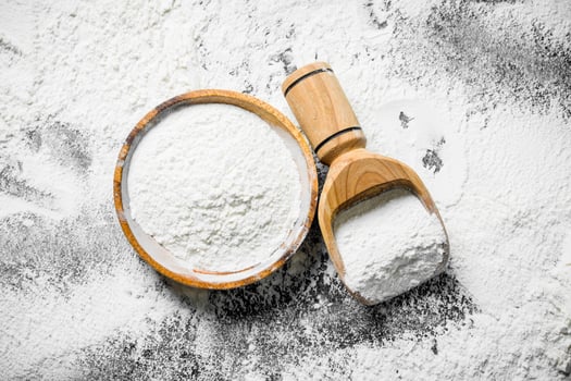Flour in a scoop and a plate. photo