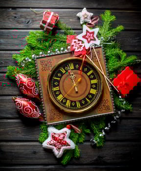 Retro clock with Christmas decorations and green fir branches. photo