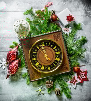 Old clock with Christmas decorations and fir branches. photo