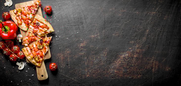 Slices of Mexican pizza with bell peppers and tomatoes. photo
