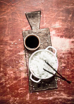 Asian food. Boiled rice with soy sauce. photo