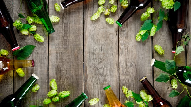Beer and green hops. On wooden table. photo