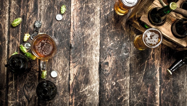 glass of fresh beer with bottles and cork. photo