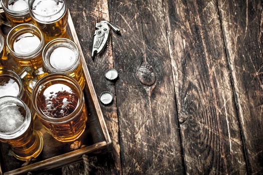 Glasses with fresh beer on an old tray. photo