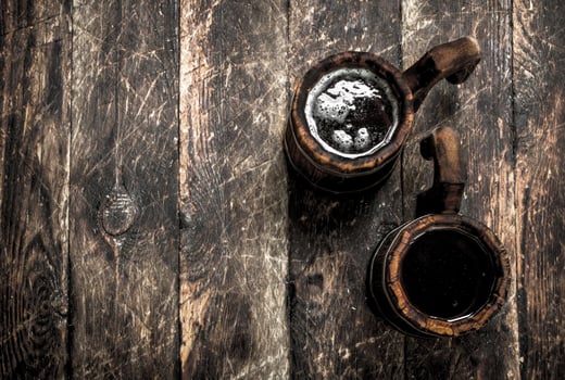 Fresh beer in a wooden mug. photo