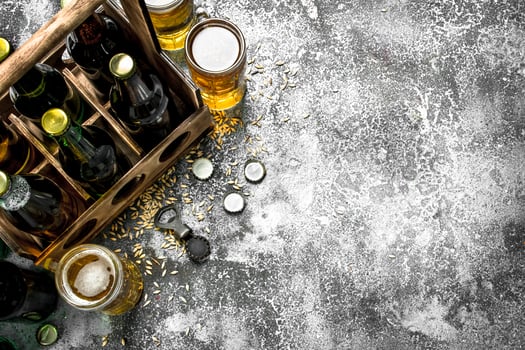 Beer background. Fresh beer in glasses and an old box. photo