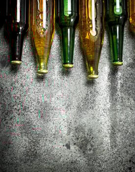 Different bottles of beer. On rustic background. photo