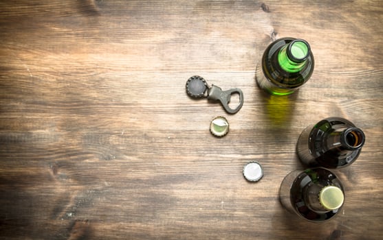 Bottles with fresh beer, opener and stoppers. photo